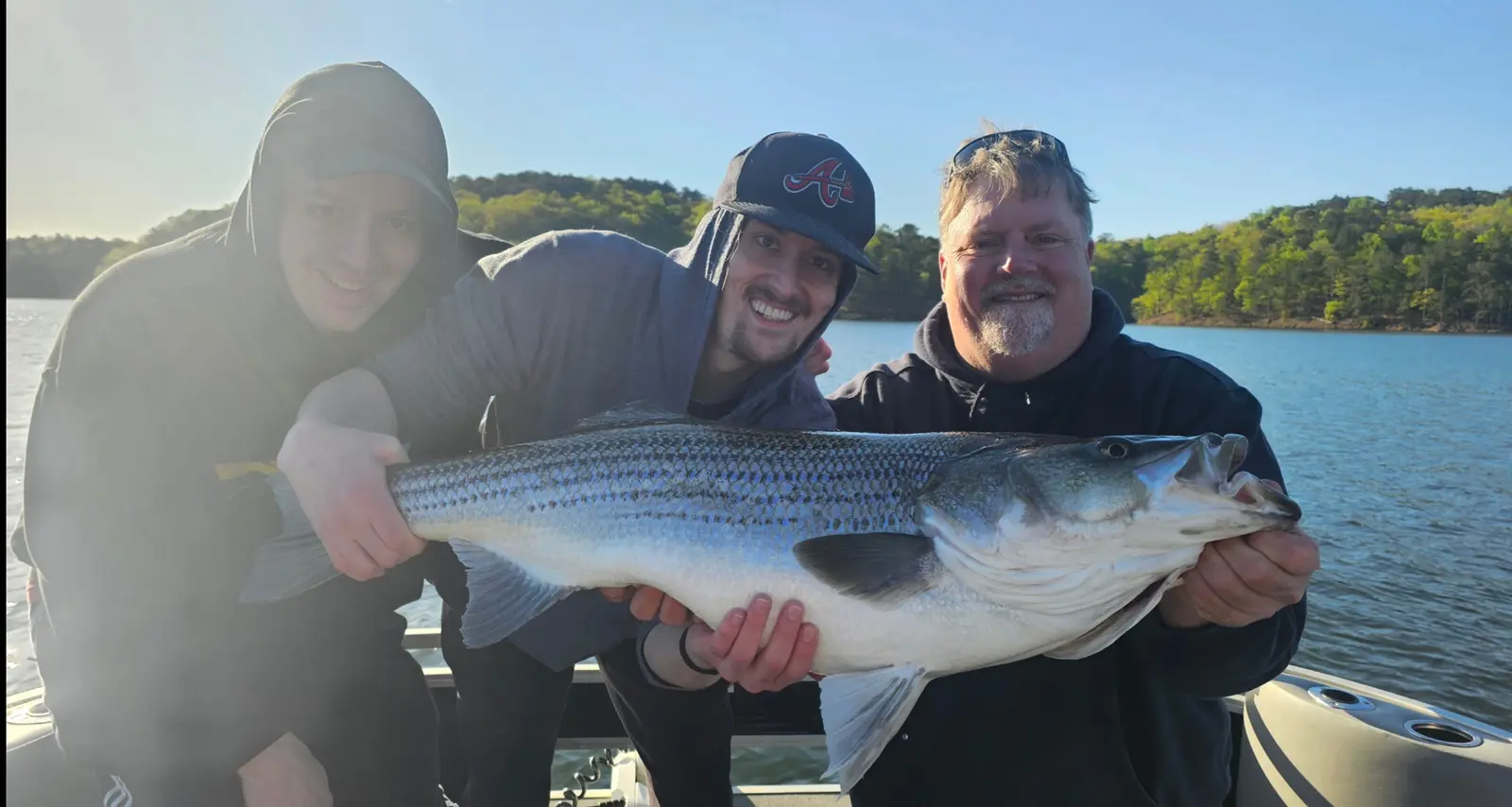 Anglers holding striped bass caught on Lake Allatoona