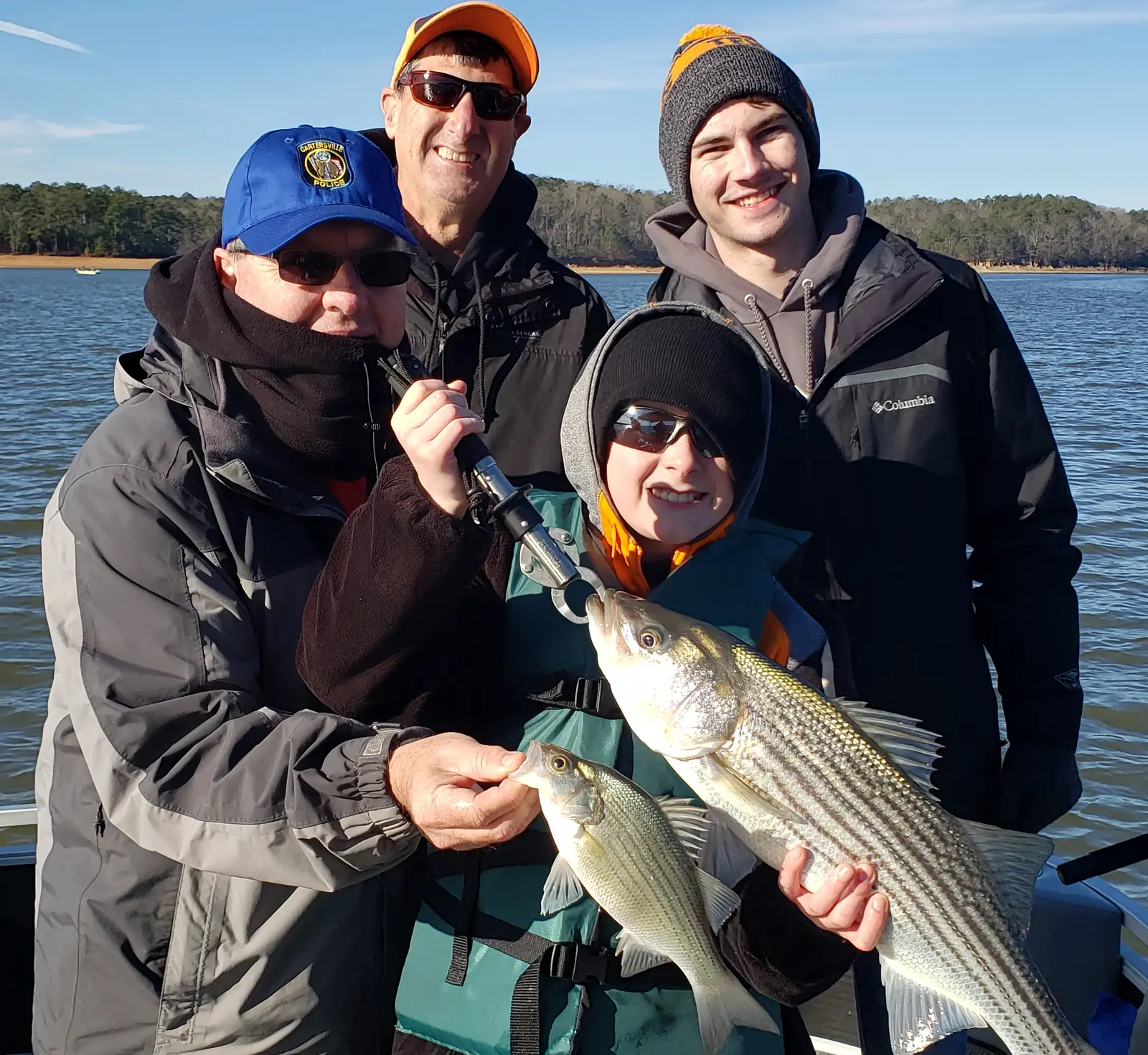 Anglers holding striped bass caught on Lake Allatoona