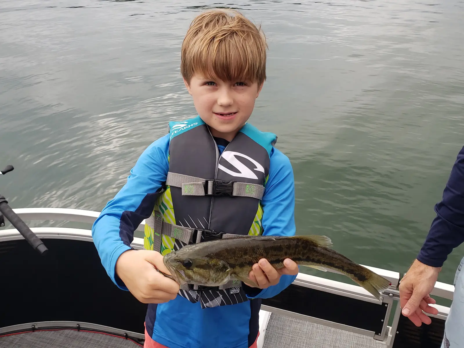 Angler holding a striped bass caught on Lake Allatoona