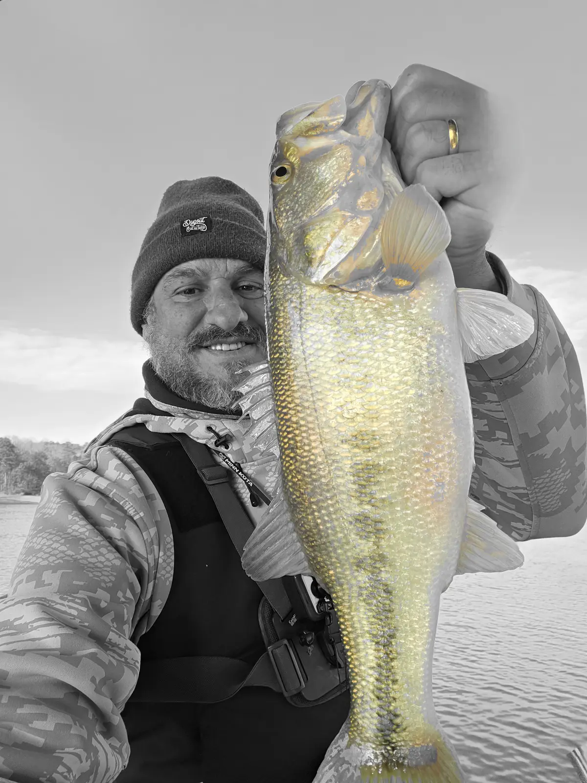 Anglers on a boat with a striped bass catch on Lake Allatoona